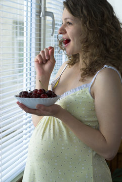 Prangnant Woman Is Eating Cherries