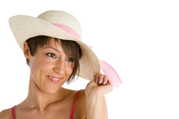 Young woman smiling wearing straw hat