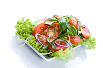 Fresh salad with onion, tomato and basil