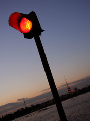 Navigation is prohibited. Closeup of red traffic light for ships