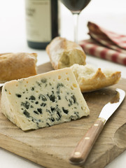 Wedge of Roquefort Cheese with Rustic Baguette and Red Wine