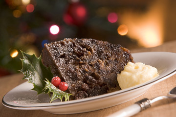 Fototapeta na wymiar Portion of Christmas Pudding with Brandy Butter