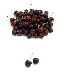 heap of sweet cherries and pair of them