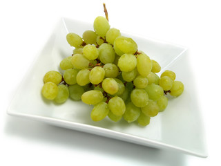 Fresh bunch of grapes in white bowl