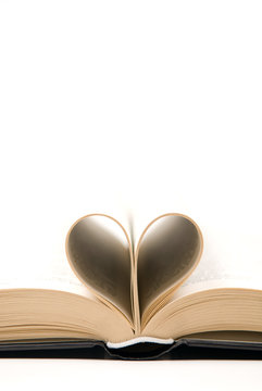 detail of romantic book with pages curved into a heart shape