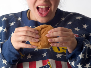 Lady eats hamburger