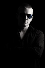 Male with Sunglasses against Black Background