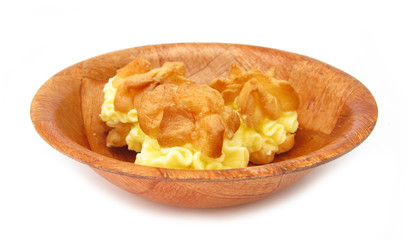 Cakes with yellow fill in wooden dish