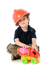 Obraz na płótnie Canvas Child with hard hat playng sitting on the floor
