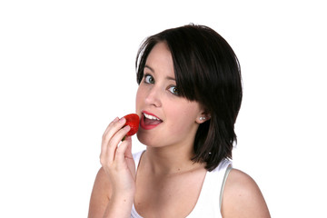 pretty brunette eating a strawberry