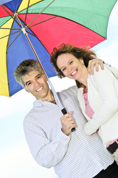 Happy Mature Couple With Umbrella