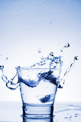 Close up view of the splash in water (toned in blue)