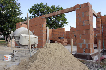A brick layer putting down another row of bricks