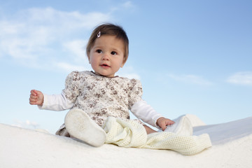 cute baby girl over sky background