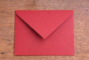 Closed Red Envelope on a Wooden Table
