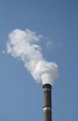 smoke stack against blue sky