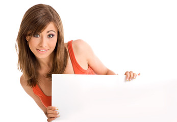 Beautiful young woman holding empty white billboard