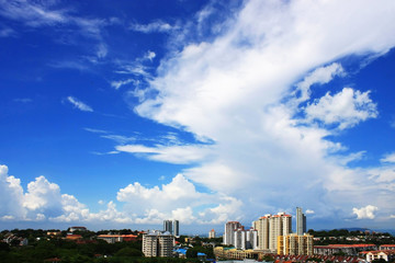 Fototapeta na wymiar Cityscape Over Cloudy Blue Sky