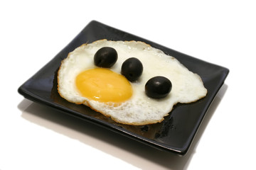 fried egg with olives on dish
