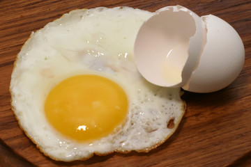 fried egg on wooden plate