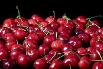 Fresh cherries isolated on black background