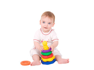 portrait of a beautiful baby girl playing with a toy