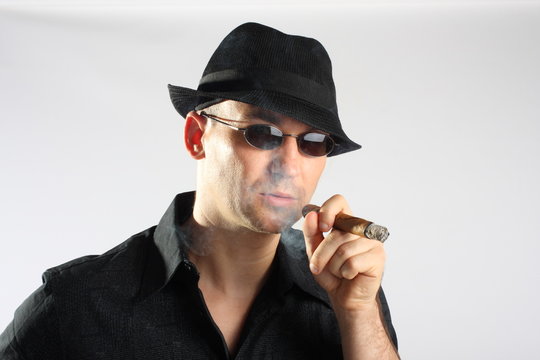 Handsome man with hat smoking a cigar