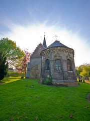 aura around church rooftop and green meadow