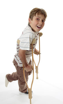 Smiling Boy On Crutches