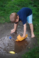 Boy Playing in a Puddle