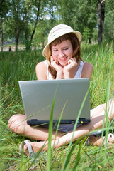 young girl with a notebook in the park