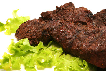 beef meat and green salad over white