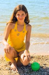 Portrait Fun girl with ball on sea background