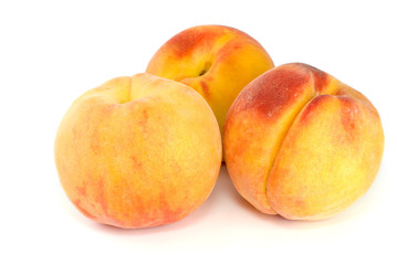 Three orange peaches