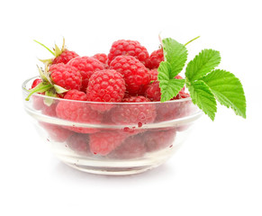 red raspberry fruits in glass vase
