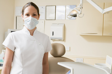 Fototapeta na wymiar Dental assistant in exam room with mask on