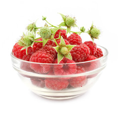 red raspberry fruits in glass vase