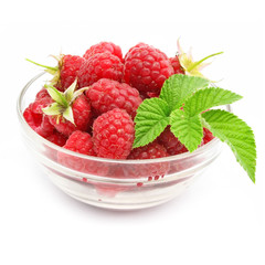 red raspberry fruits in glass vase