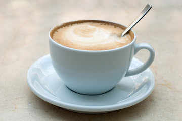 Cup of cappuccino on a table in Kiev indoor cafe