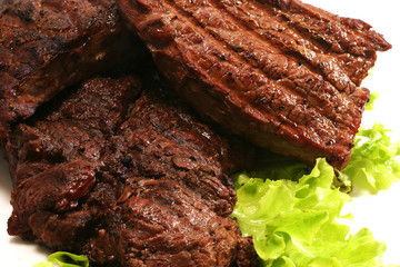 grilled beef meat and green salad over white