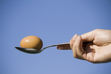 egg and spoon against blue sky