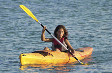 Young girl learning to kayaking
