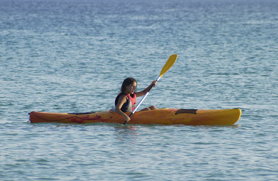 Young girl learning to kayaking