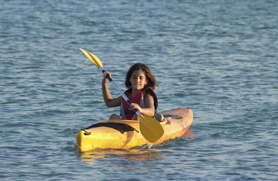 Young girl learning to kayaking
