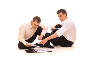 businessmen scrutinizing contracts