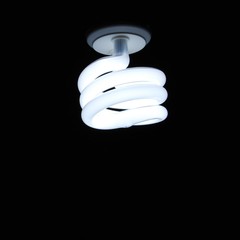 Energy saving lightbulb against black background