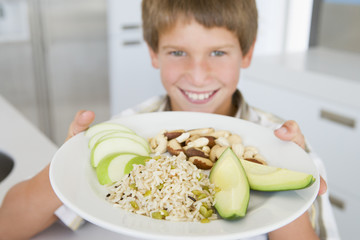 Boy holding plate of food