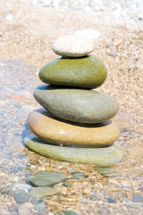 Fototapeta na wymiar balanced stones on the water