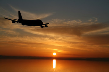 Plane flying towards sunset illustration