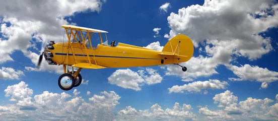 Fotobehang Oud vliegtuig Vintage tweedekker boven wolken